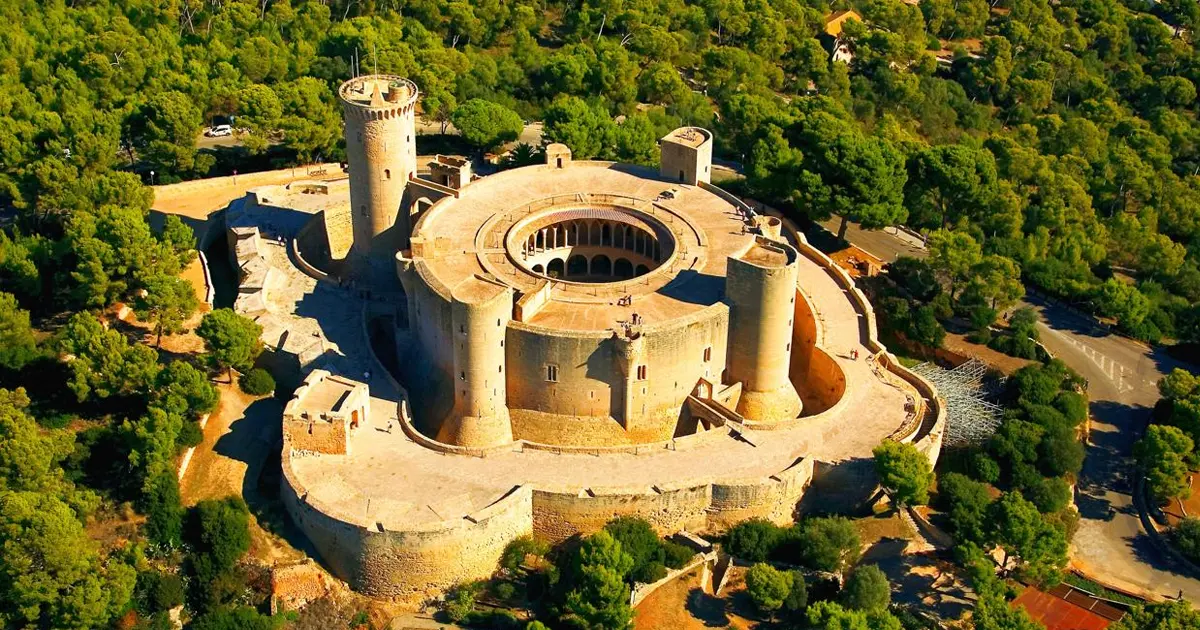 Estructura de planta circular y torre del Castillo de Bellver rodeado de pinada en Palma